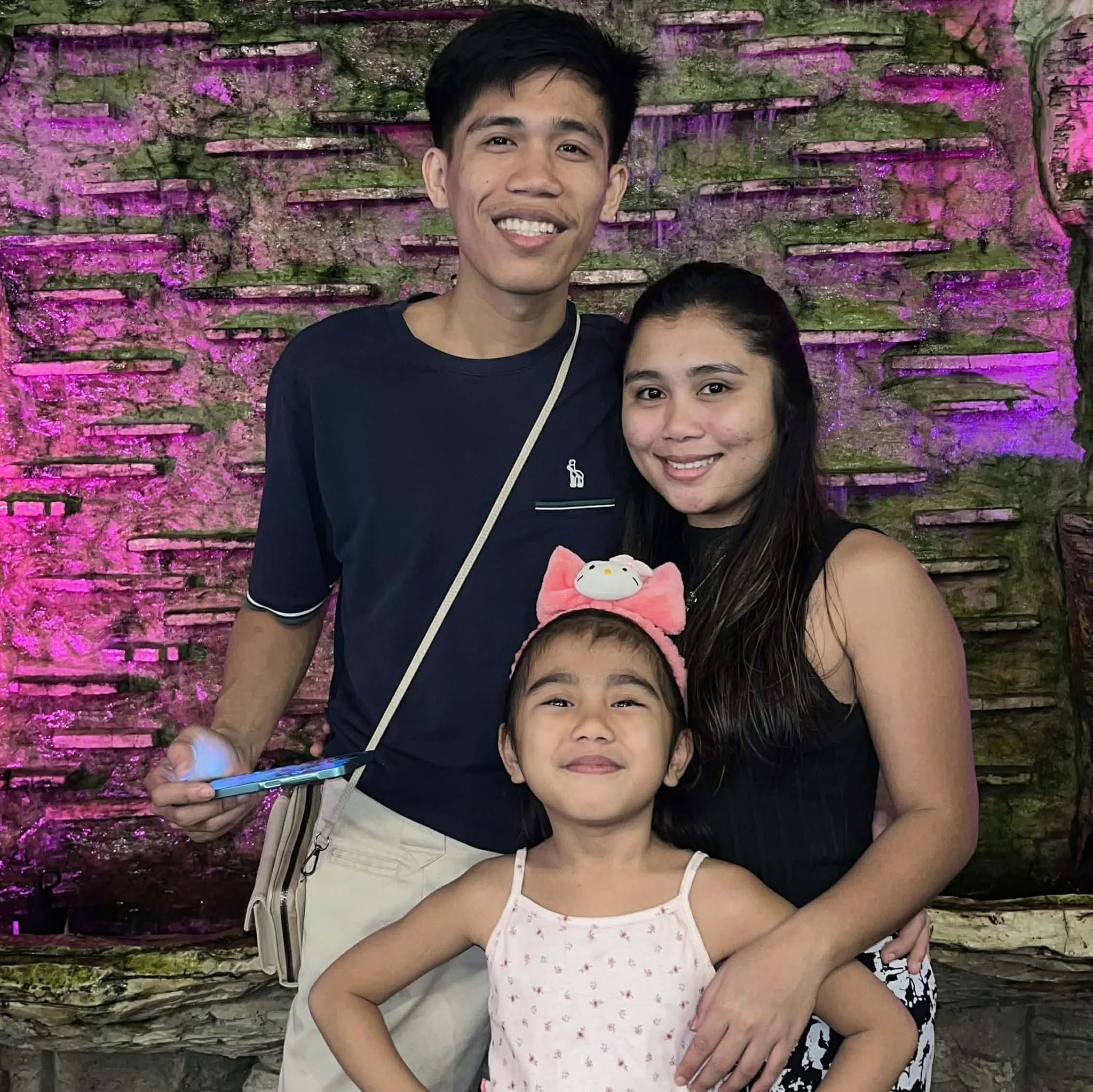 Kyle with his family, smiling together.